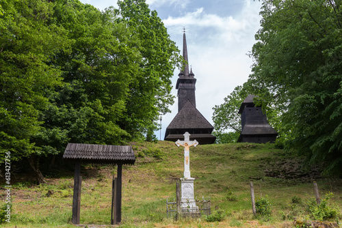 Medieval Gothic wooden church, bell tower in Danylovo village, Ukraine photo