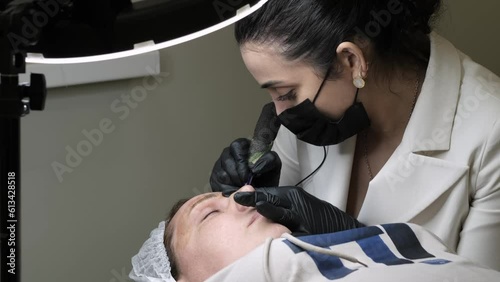 professional approach to microblading, emphasizing the expertise needed to achieve stunning results. cosmetic product manufacturers who sell eyebrow tattooing equipment or aftercare products. photo