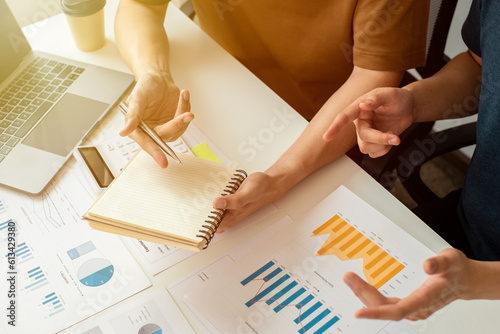 Business owners and partners analyze earnings charts to plan investments for the next quarter, optimizing their decision-making and maximizing returns.