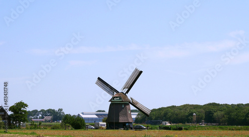A single windmill standing on a field in the Netherlands