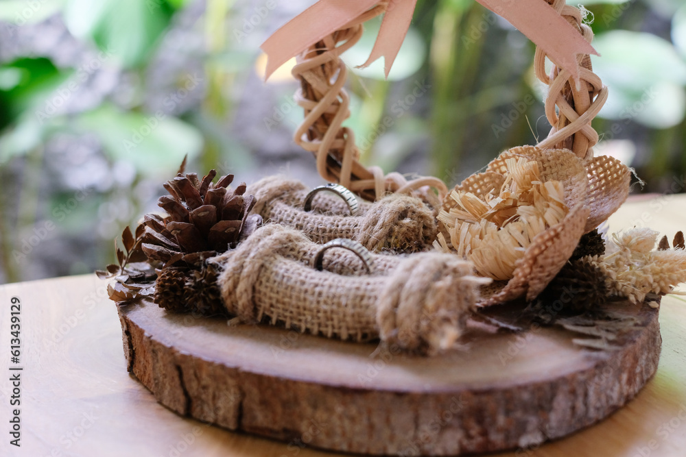a rustic ring case or jewelry box made of wood and rattan. Wedding rings, wedding decoration and wedding concept a rustic ring case or jewelry box made of wood and rattan. Wedding rings, wedding decoration and wedding concept