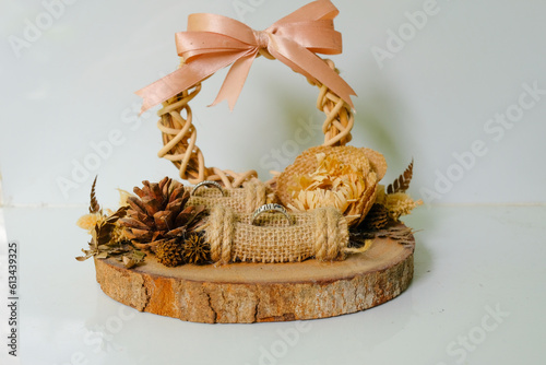 a rustic ring case or jewelry box made of wood and rattan. Wedding rings, wedding decoration and wedding concept