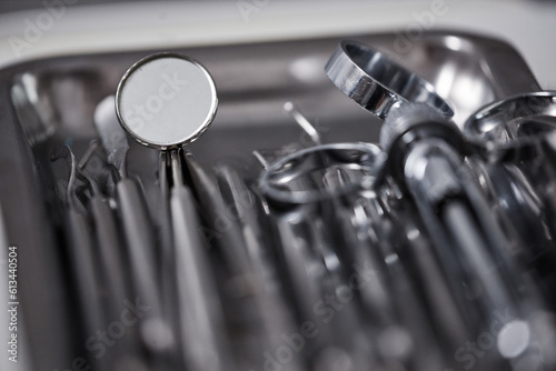Macro shot of metal sterile tools set with mirror in dental clinic, copy space