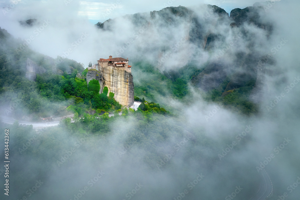 Meteora Monastery of Roussanou rising out of the mist. Aerial, mystical panoramic landscape.  A UNESCO World Heritage Site. Greece.