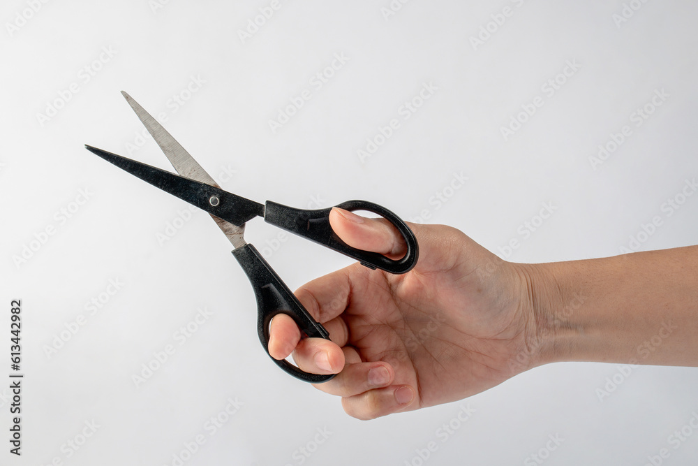 Office stationery scissors cutting in hand on white background Office stationery scissors cutting in hand on white background