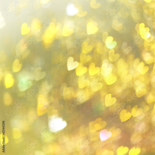 Blurred background in yellow tones .Abstract small hearts flare blur background. Heart shaped sun reflection.
