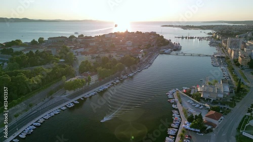 Flying to sunset over Zadar old town and marina Jazine in Croatia photo