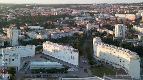 Aerial close up shot over wide spread town, urban architecture mixed with traditional houses in Zadar, Croatia. photo