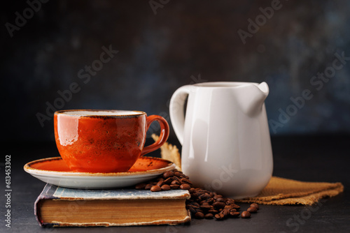 Rich coffee in a cup with aromatic roasted beans