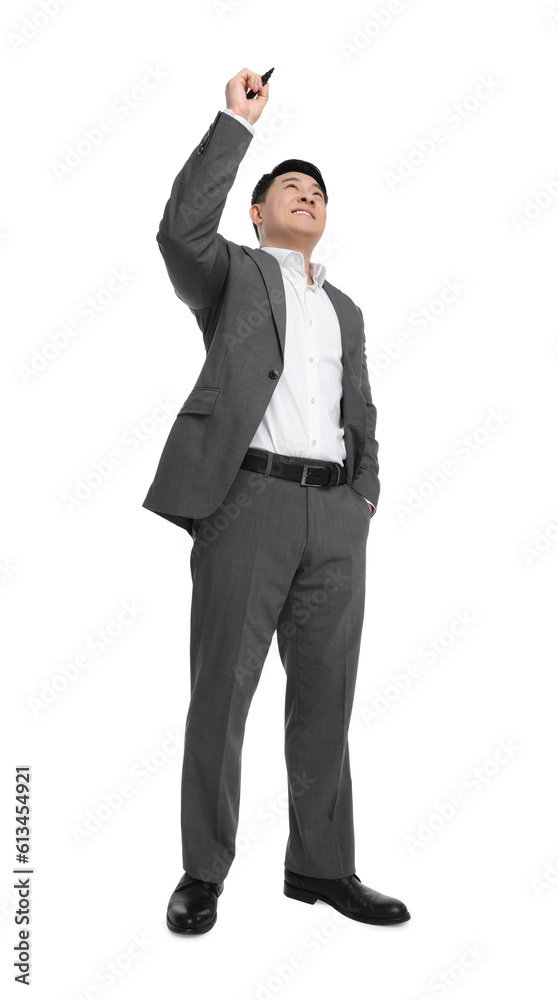 Businessman in suit with marker writing on white background, low angle view Businessman in suit with marker writing on white background, low angle view