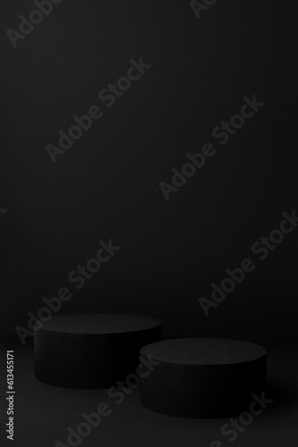 Abstract black scene with two cylinder podiums template for presentation cosmetic products, goods, advertising, design, sale, text in soft gradient, mockup in minimalism style, vertical, copy space.