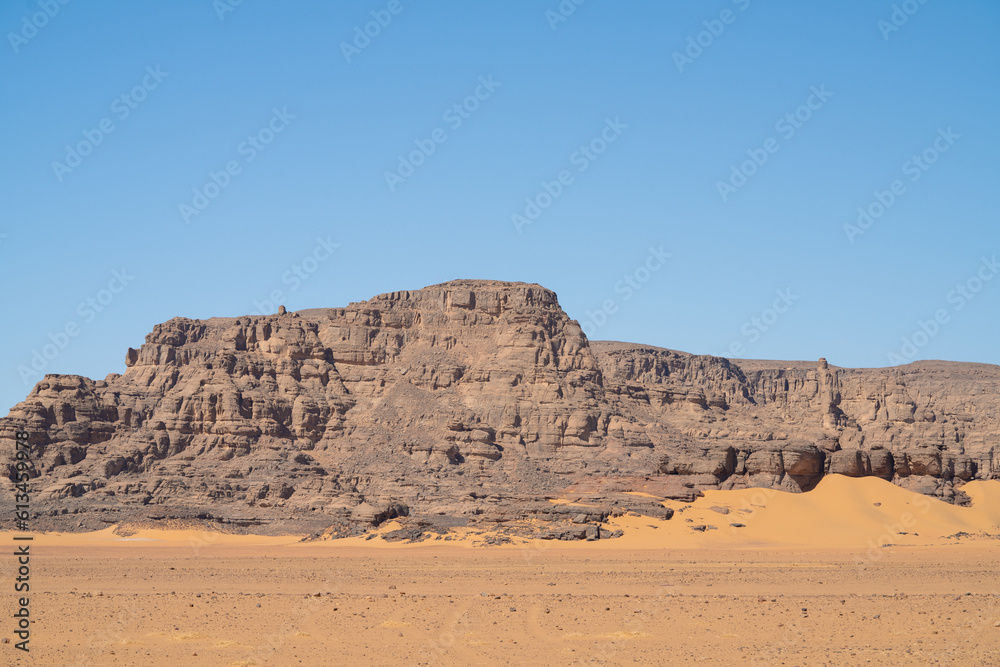 view in the Sahara desert of Tadrart rouge tassili najer in Djanet City ,Algeria.colorful orange sand, rocky mountains view in the Sahara desert of Tadrart rouge tassili najer in Djanet City ,Algeria.colorful orange sand, rocky mountains