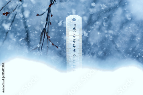 Precipitation snow level. line.Winter time. The soft focus ruler on the snow shows the amount of snowfall in centimeters.Measuring stick for snow.