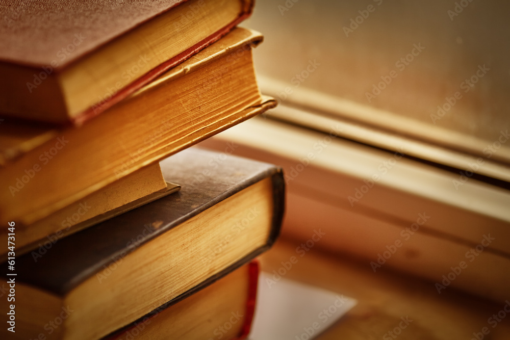 Old books on the windowsill. Old books. Old multi-colored books.Background from old books,a stack of old vintage books lies on the windowsill.Copy space Old books on the windowsill. Old books. Old multi-colored books.Background from old books,a stack of old vintage books lies on the windowsill.Copy space