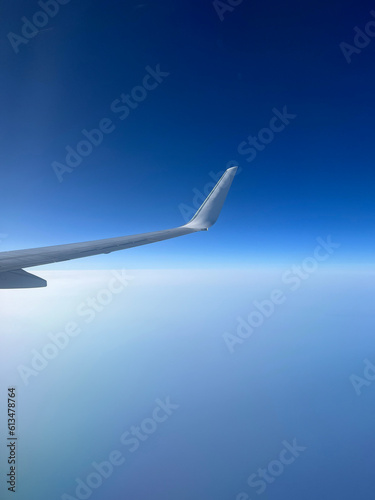 View from the airplane window. Beautiful cloudscape with blue sky. Wonderful panorama above white clouds as seen through window of an plane.