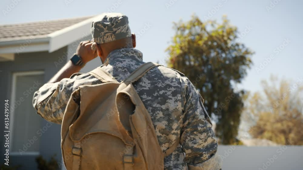 Young soldier, in camouflage clothing, returning home from deployment in the US military