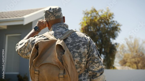 Young soldier, in camouflage clothing, returning home from deployment in the US military