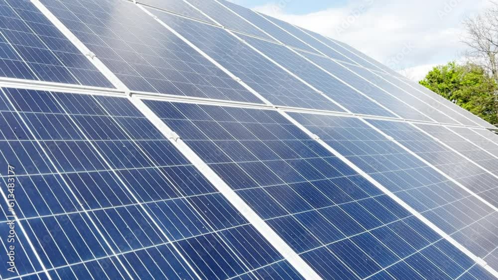 Solar panels in a solar park used for clean energy production. Solar panel under blue sky with sun Solar panels in a solar park used for clean energy production. Solar panel under blue sky with sun