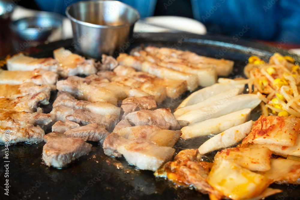 Fresh and delicious iron pan-fried black pork meal in Jeju Korean restaurant.