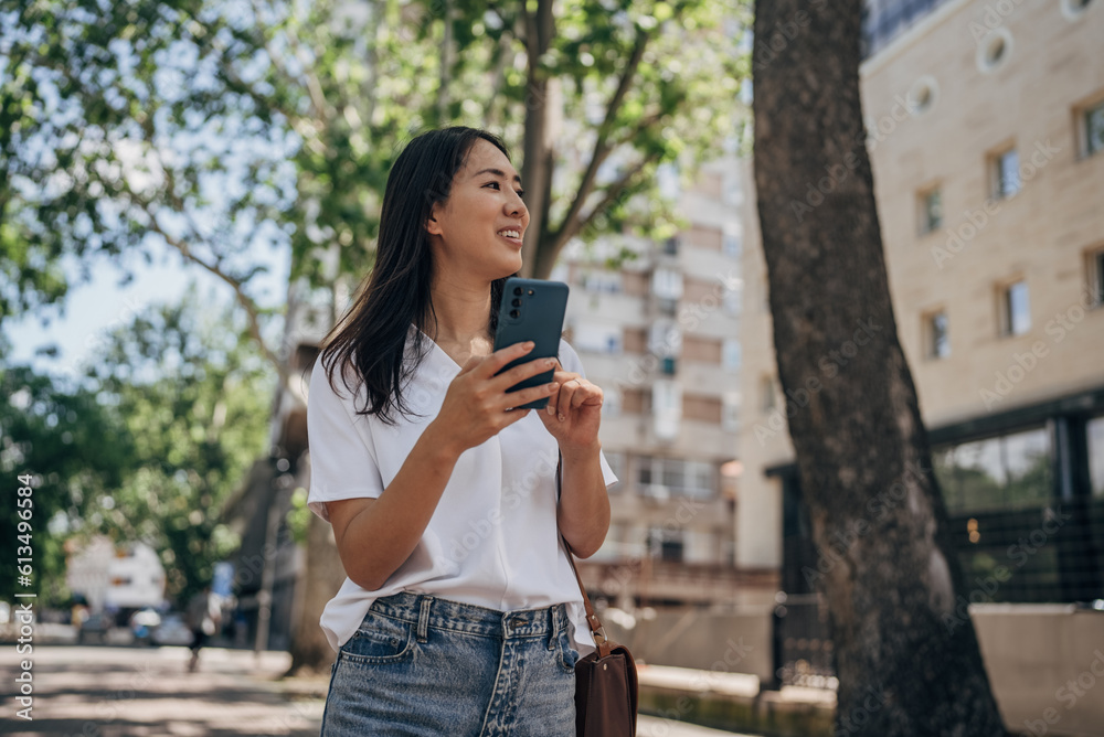 Young woman using smart phone in the city