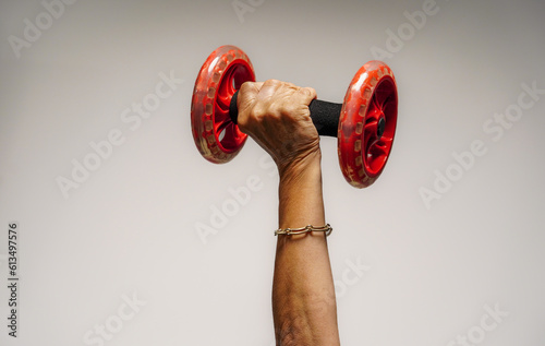 a female hand with a dumbbell in the gym. girl power in the sport photo