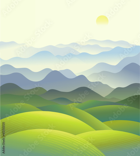 Hilly landscape with a panorama of mountain ranges in the fog.