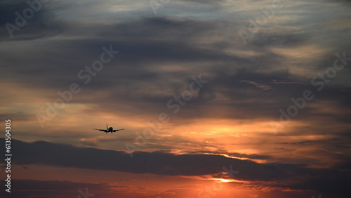 landing airplane on the background of the sunset