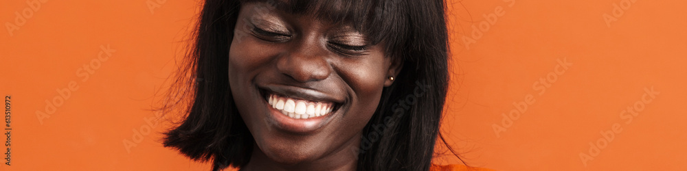 Young beautiful smiling african woman with closed eyes Young beautiful smiling african woman with closed eyes
