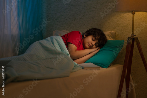Portrait of little boy sleeping on bed