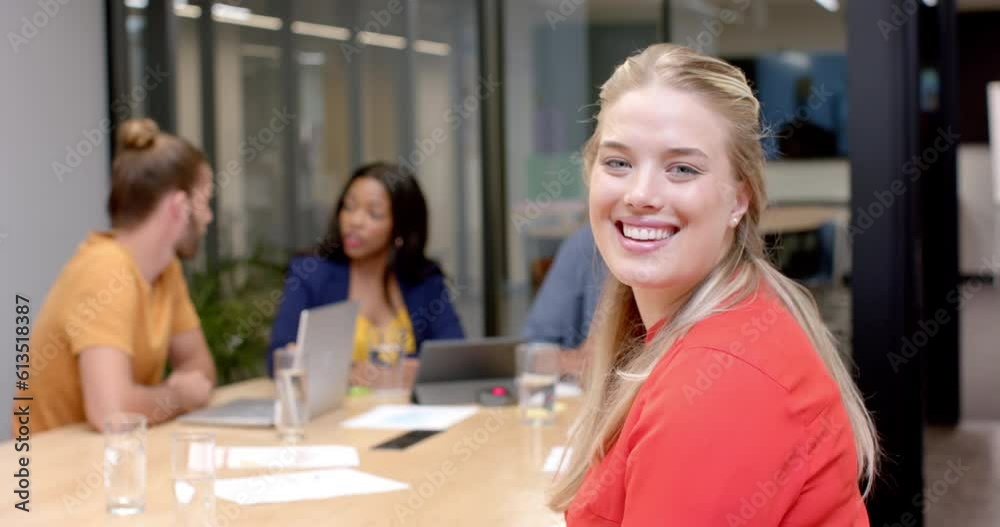 Portrait of happy caucasian casual businesswoman with diverse colleagues at office meeting