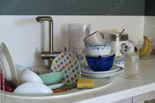 Принти на полотні Kitchen chaos: An overwhelming pile of dirty dishes awaits cleaning in the sink, with a sponge lying nearby