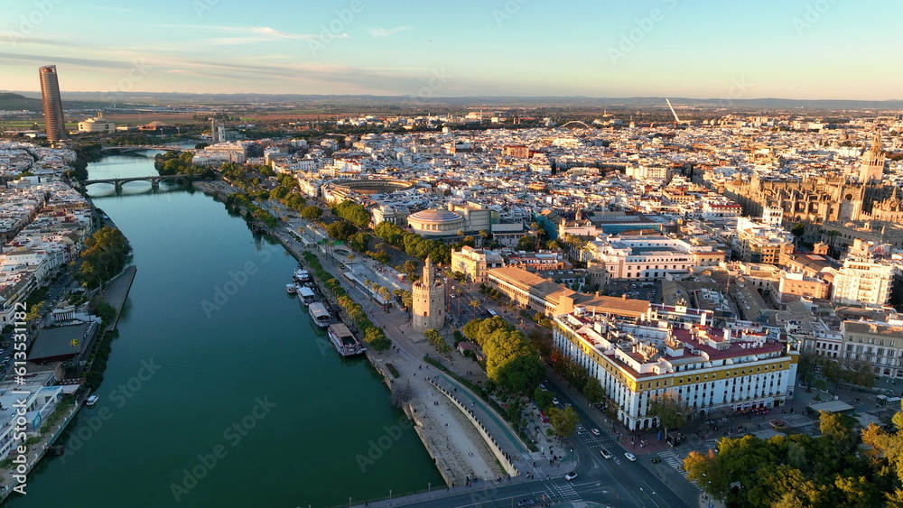 Naklejka premium Aerial drone footage of the Seville city the Guadalquivir canal with the cathedral, the Torre del Oro, the tower of gold, Andalusia, Spaine