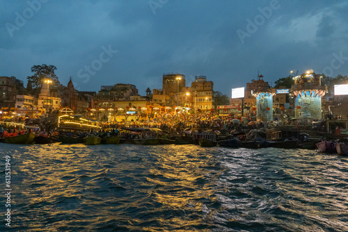 India Varanasi ganga ghat at night, view of the crowded banks of people and funeral pyres