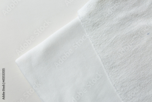 A twisted piece of white fabric. White knitwear material on a white background.