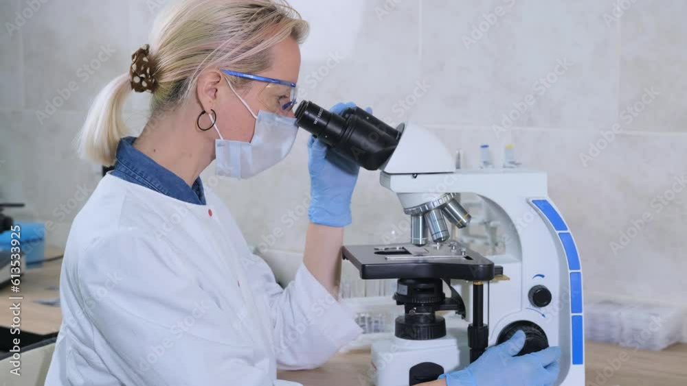 A laboratory assistant examines samples under a microscope. Scientific research in the laboratory. The concept of developing new medicines. Achievements in the field of biotechnology. A laboratory assistant examines samples under a microscope. Scientific research in the laboratory. The concept of developing new medicines. Achievements in the field of biotechnology.
