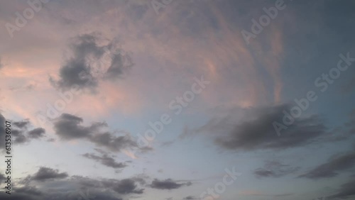 Orange cirrus dissapear and dark clouds appear in his place at sunset photo