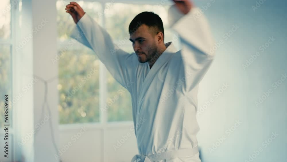 Martial art school student In white kimono warming up before training, sparring Martial art school student In white kimono warming up before training, sparring