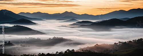 Misty valley panoramic landscape with mountains, hills and trees.