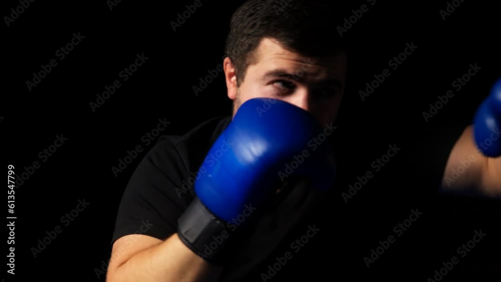 Close-up of a young boxer punching air, solo training routine, shadow boxing Close-up of a young boxer punching air, solo training routine, shadow boxing