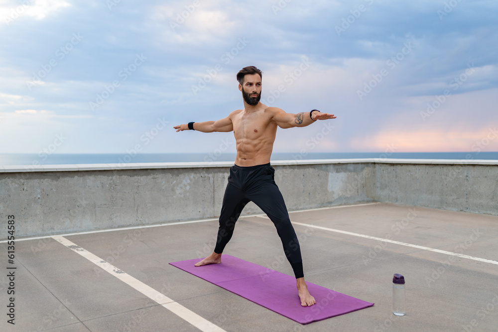 attractive hansome man with athletic strong body doing morning yoga asana outdoors attractive hansome man with athletic strong body doing morning yoga asana outdoors