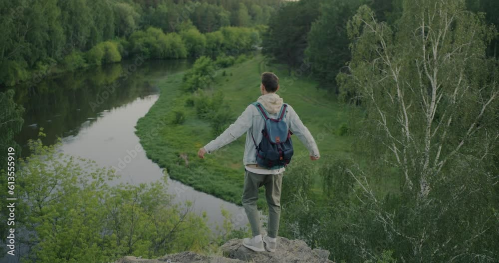 Slow motion of young man tourist walking in mountains waving hands enjoying beautiful landscape and nature. Tourism and travelling concept. Slow motion of young man tourist walking in mountains waving hands enjoying beautiful landscape and nature. Tourism and travelling concept.