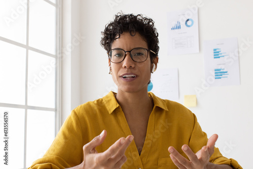Woman discussing with her business team over a video call photo