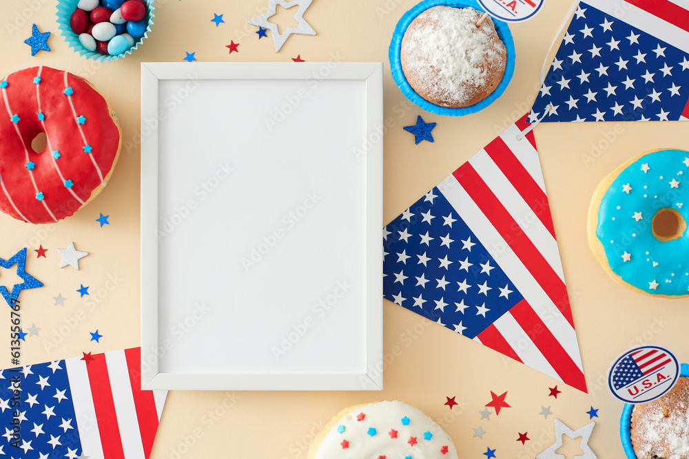 Obraz premium Get ready for a confectionary party on the 4th of July. Top view flat lay of donuts, candies, cupcakes, american flag garlands, stars on light beige background with blank frame for text or ad