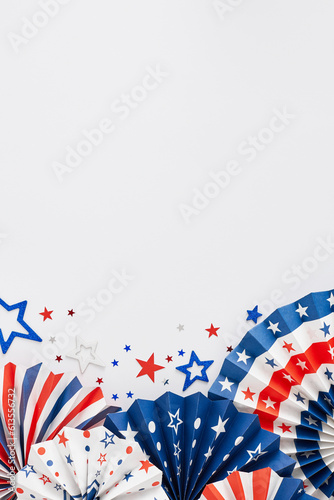 American Independence Day Party concept. Top view vertical flat lay of folding fans, star-shaped confetti on white background with space for ad or message