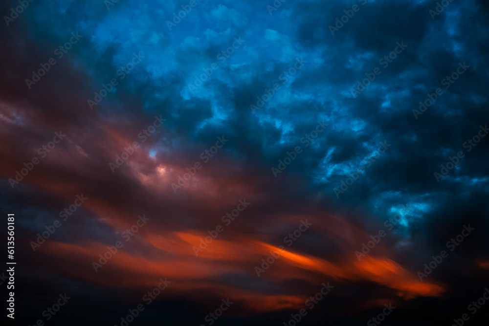 Colorful sunset with dark clouds. Natural beautiful landscape of sky.