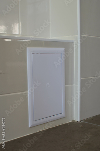 closed plastic inspection sanitary hatch in the wall.