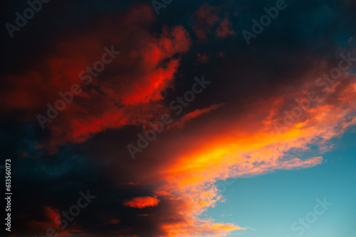 Colorful sunset with dark clouds. Natural beautiful landscape of sky. © Lalandrew