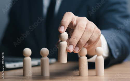 Business hiring and recruitment selection. Human Resource Management.Red manager icon staff employee icon which print screen on wooden people, Choice of employee leader from the crowd..