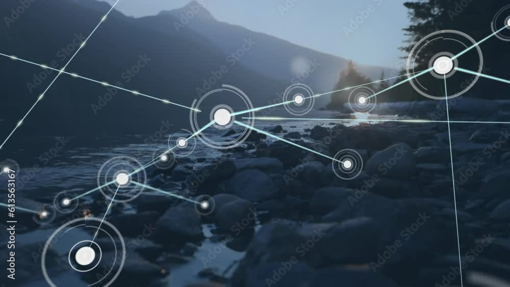 Animation of connected dots over river flowing between mountains against sky