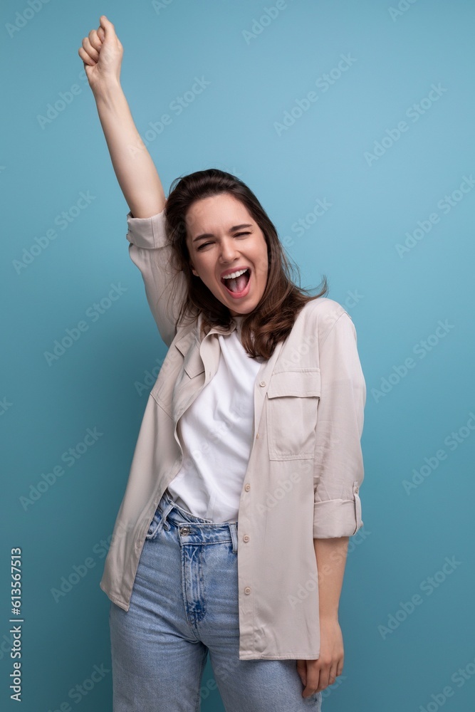 happy 30s woman with chic black hair below her shoulders in a beige shirt raised her hand up happy 30s woman with chic black hair below her shoulders in a beige shirt raised her hand up